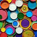 Brightly coloured painted tin lids
