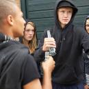 Young people drinking by some garages