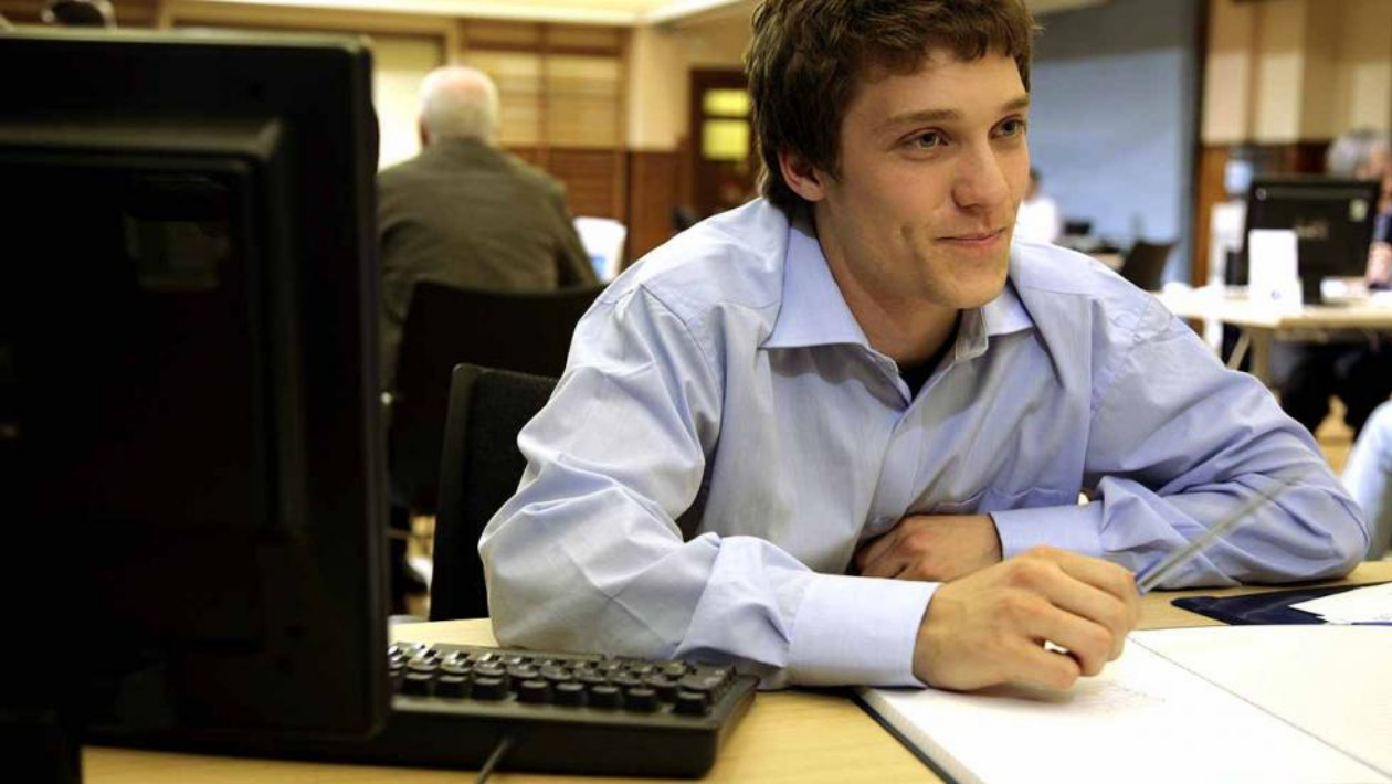 young person sat at a computer 