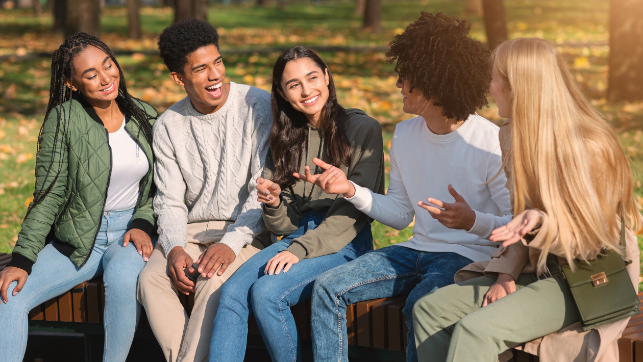 Teens sat outside in autumn