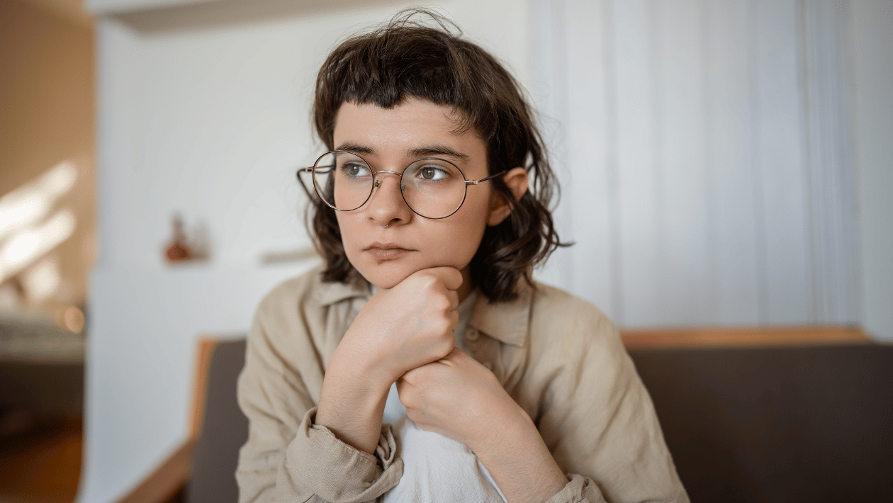 young person sat looking away from camera