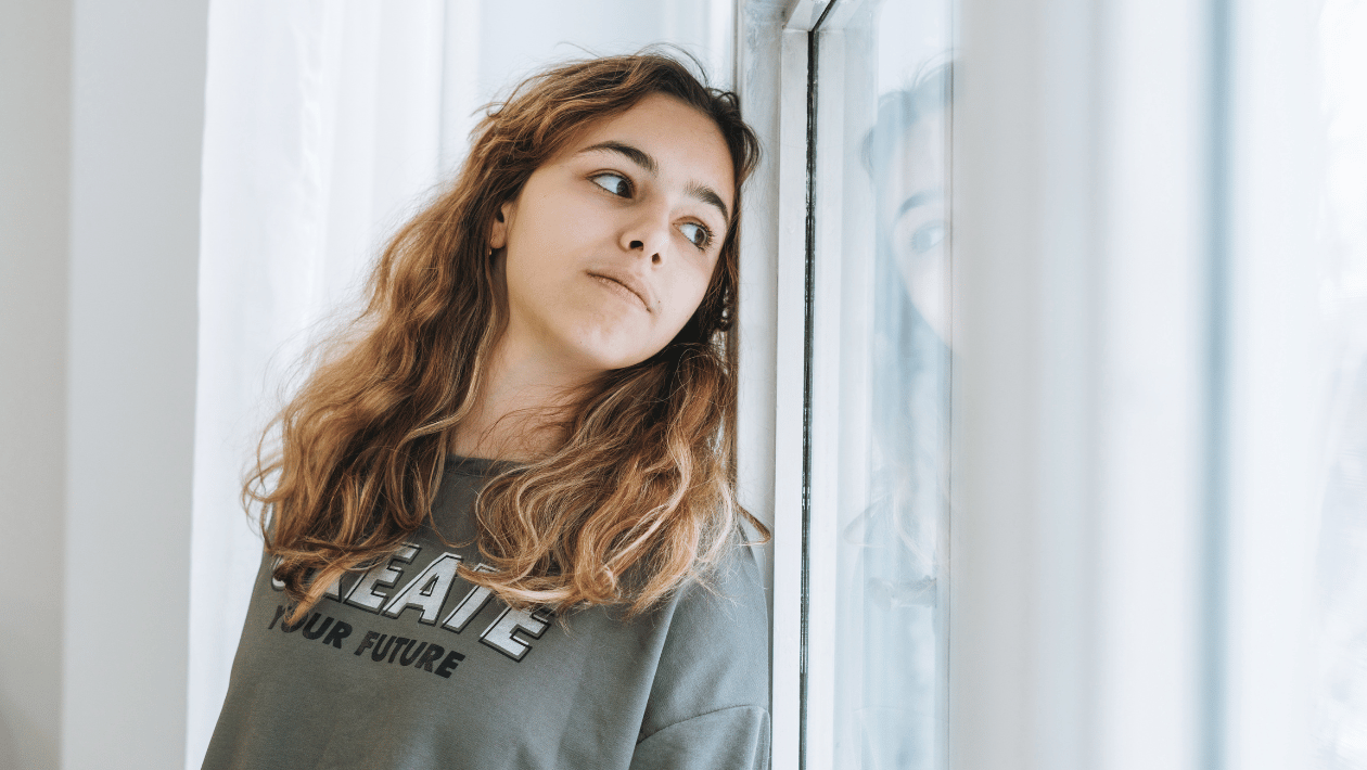 Young person looking out of window