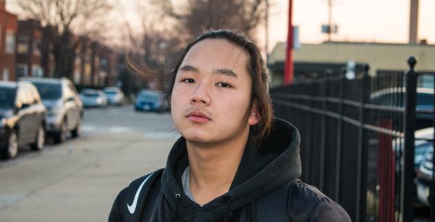 young boy standing outside