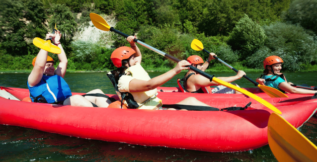 Young people in boats on a river