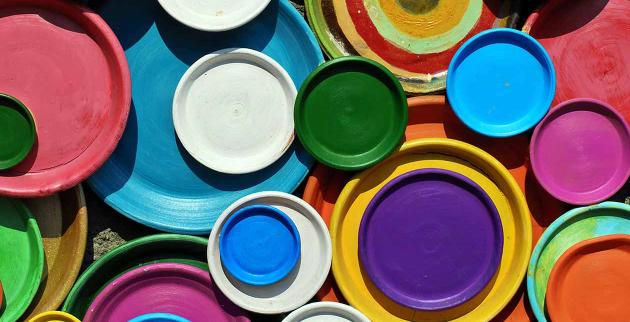 Brightly coloured painted tin lids