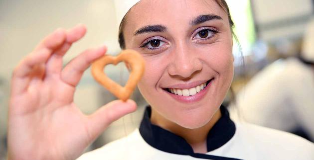 Young chef holding a pastry