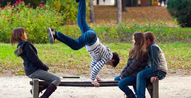 Young people practising parkour in a park