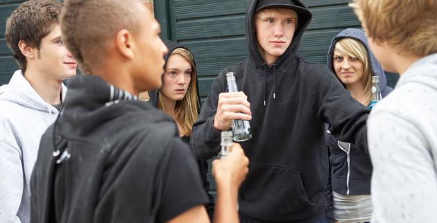 Young people drinking by some garages