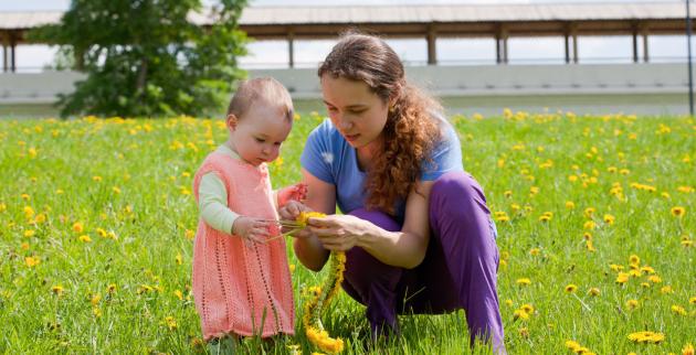 Young mum playing in a meadow