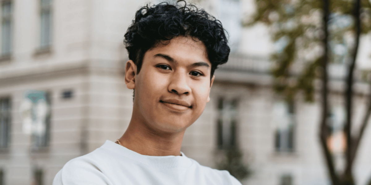 young person looking at camera outside