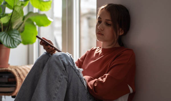 young person sat by window