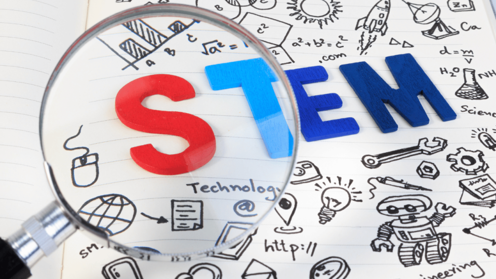 magnifying glass pointing over the word STEM