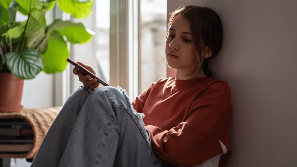 young person sat by window