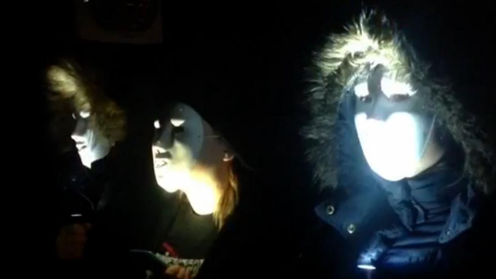 Three people in coats and white masks