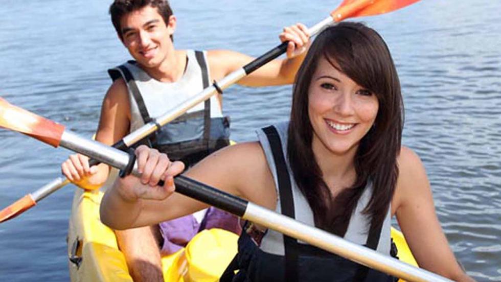 girl and boy kayaking