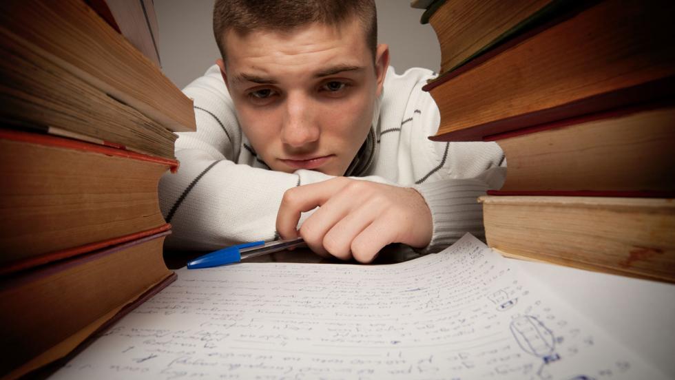 stressed boy with books