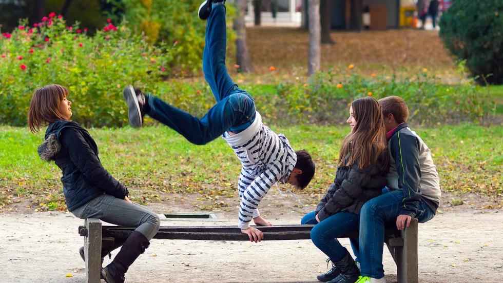 Young people practising parkour in a park