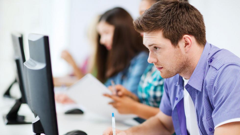 young man looking at a computer