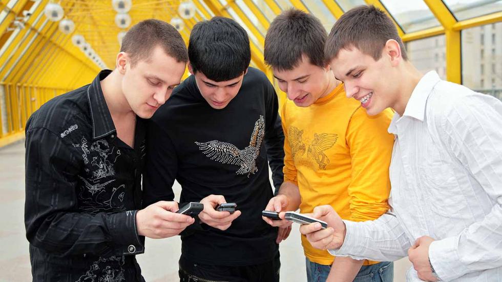 Young men looking at their mobile phones