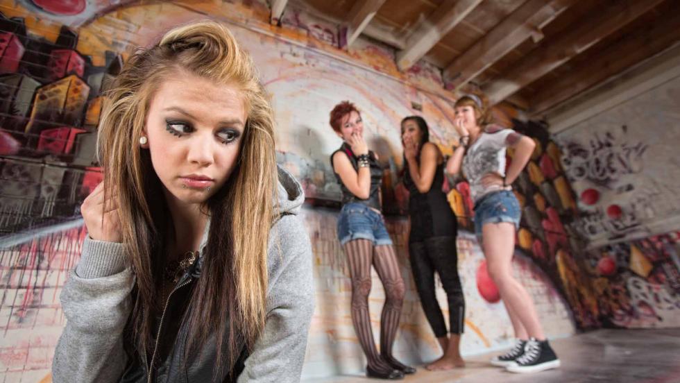 Group of young women, one looking anxious