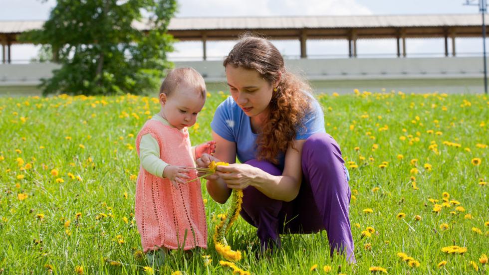 Young mum playing in a meadow