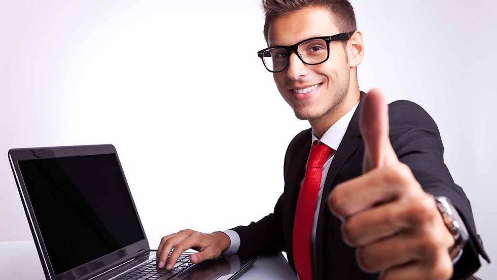 Young man smiling laptop
