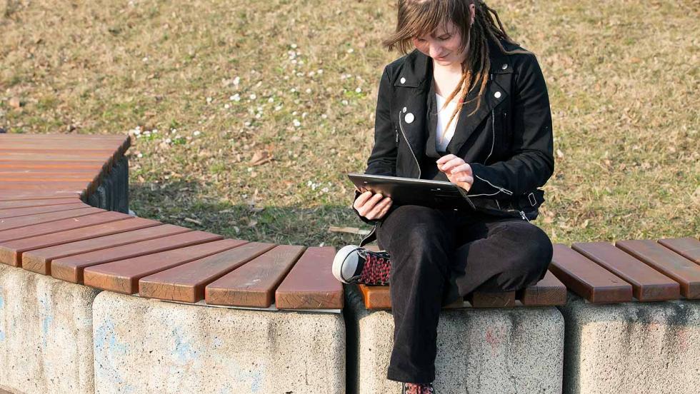 Young woman reading on a tablet