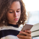 young person holding a phone