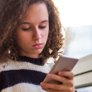 young person holding a phone 