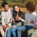 Teens sat outside in autumn