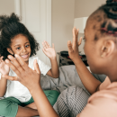 Mother and daughter clapping hands