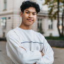 Young person stood with arms crossed