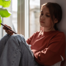young person sat by window