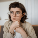 young person sat looking away from camera