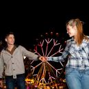 Young man and young woman visiting a fairground