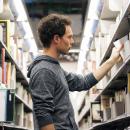 Young man selecting a library book
