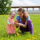 Young mum playing in a meadow