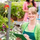 A young woman works at a garden centre