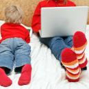 Two young people using a lap-top and a tablet to browse websites